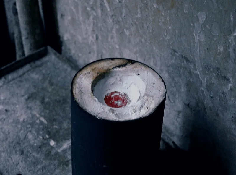 Molten metal glowing inside a crucible